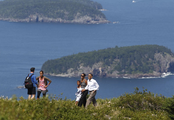 U.S. President Barack Obama (R) and his wife Michelle (2nd R) walk along a trail with their daughters Sasha (C) and Malia on Cadillac Mountain in Bar Harbor, Maine, July 16, 2010. The First Family is on vacation for the weekend. [Xinhua]