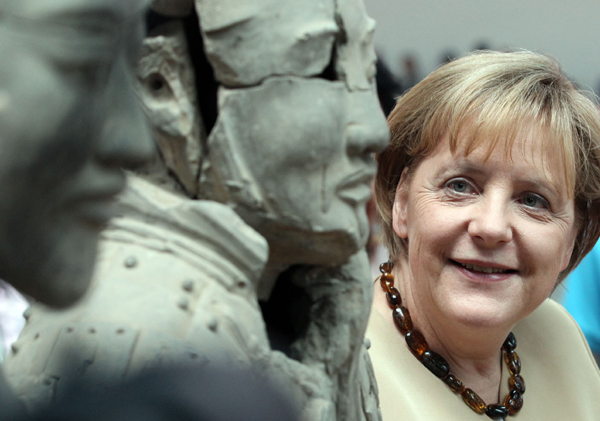 German Chancellor Angela Merkel marvels at the terracotta warriors on Saturday in Xi&apos;an, capital of Shaanxi province. She celebrated her 56th birthday in the city, where she received a taste of traditional Chinese hospitality and culture. [China Daily] 