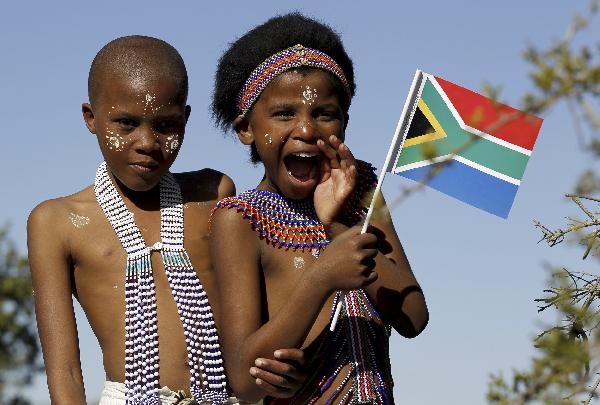 A child holds a South African national flag during former South African president Nelson Mandela&apos;s 92nd birthday celebrations at Mvezo, about 70km from Mthatha, in the Eastern Cape July 18, 2010. Mvezo is the birth place of former president Mandela who did not attend the celebrations as he was spending time with his family in Johannesburg.[Xinhua/Reuters]