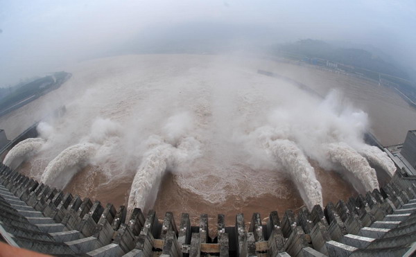 Floodwater rushes through the sluice gates of the Three Gorges Dam in Yichang, central China&apos;s Hubei province on July 19, 2010. [Xinhua]