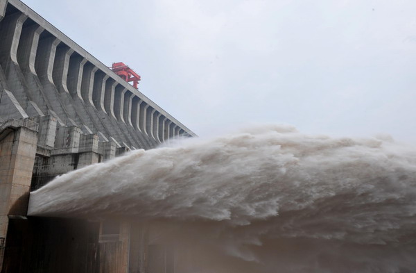 Floodwater rushes through the sluice gates of the Three Gorges Dam in Yichang, central China&apos;s Hubei province on July 19, 2010. [Xinhua]