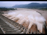 Floodwater rushes through the sluice gates of the Three Gorges Dam in Yichang, central China's Hubei province on July 19, 2010. The reservoir's inflow rose up to 58,000 cubic meters a second at 8:00 am this morning, the highest this year. [Xinhua]