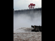 Floodwater rushes through the sluice gates of the Three Gorges Dam in Yichang, central China's Hubei province on July 19, 2010. [Xinhua]