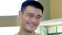 Yao Ming talks with reporters during an interview as he arrives at a basketball training centre in Shanghai.