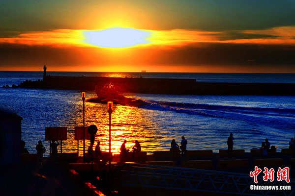 With its landscape rimmed in golden sunlight, the Fisherman's Wharf in Tamshui, a city north to Taipei in Taiwan, teems with tourists in this photo taken in late July, 2010. The wharf used to be the second-largest fishing harbor in Tamshui before it was made into a scenic spot. [Photo: Chinanews.com]