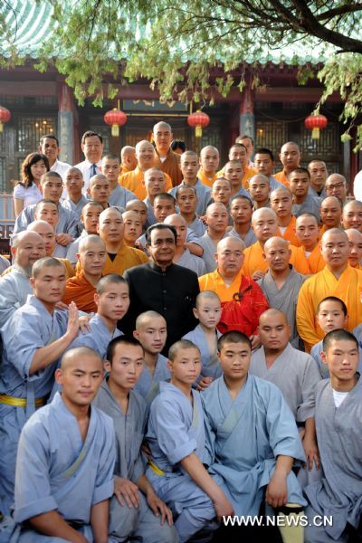 Sri Lankan Prime Minister D.M. Jayaratne (C) poses for a group photo with monks at the Shaolin Temple located on Songshan Mountain in central China&apos;s Henan Province, July 20, 2010. Jayaratne visited the world-renowned Shaolin Temple on Tuesday. The 1,500-year-old temple is regarded as one of the holy sites of Chinese Kungfu.[Zhu Xiang/Xinhua]