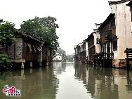 Wuzhen as part of Tongxiang in northern Zhejiang Province, lies within the triangle formed by Hangzhou, Suzhou and Shanghai. It displays thousands of years of history in its ancient stone bridges floating on mild water, its stone pathways between the mottled walls and its delicate wood carvings. Also, it gives a unique experience through its profound cultural background, setting it apart from other towns. [Photo by Xiaoyong]