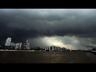 Dark clouds hang heavily over Guangzhou City, south China's Guangdong Province, July 21, 2010. Chanthu, the third tropical storm of the year, which strengthened early Wednesday is forecasted to land on south China's Hainan and Guangdong Province on July 22. [Xinhua]