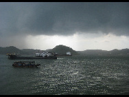 Dark clouds hang heavily over the Qisha Peninsula in Fangchenggang City, south China's Guangxi Zhuang Autonomous Region, July 21, 2010. 