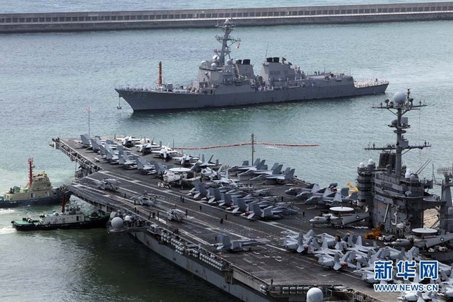 The U.S. nuclear-powered aircraft carrier USS George Washington moves to come alongside the pier at a port in Busan, about 420 km (262 miles) southeast of Seoul, July 21, 2010. The aircraft carrier will participate in a massive combined air and naval exercise to be held by South Korea and the U.S. in the East Sea from July 25 to 28 to show deterrence plans against North Korea. [Xinhua]