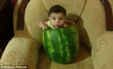 The unidentified child was captured on video sitting inside the huge hollowed-out fruit in the latest YouTube sensation. [cntv.cn/Ruckus]