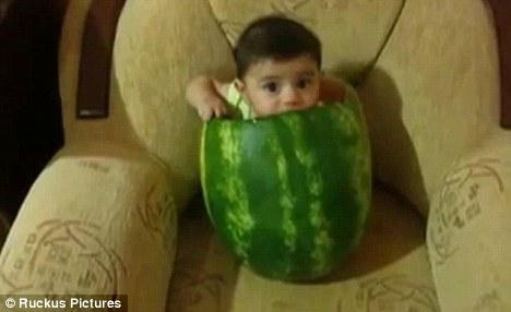The unidentified child was captured on video sitting inside the huge hollowed-out fruit in the latest YouTube sensation. [cntv.cn/Ruckus]