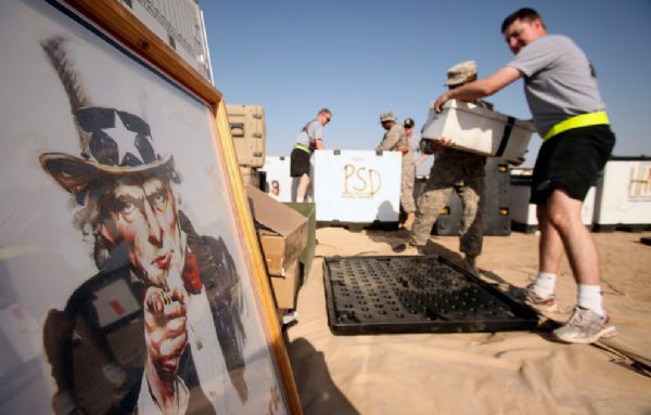 A poster depicting &apos;Uncle Sam&apos; is seen at left as U.S. Army soldiers from the 49th Military Police Brigade pack up their gear as the unit prepares to ship their equipment and belongings home Sunday, July 18, 2010 at Camp Victory in Baghdad, Iraq. The soldiers, based in Fairfield, California, are soon to head home after ten months in Iraq as part of the U.S. drawdown of forces, which begins in earnest next month.[yeeyan.org]