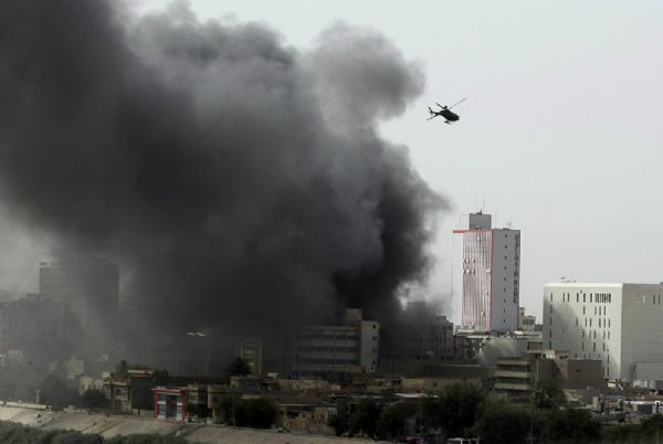 A U.S. army helicopter flies over an area where several explosions rocked the Iraqi capital Baghdad on June 13, 2010 within minutes of each other, killing at least two people, according to an interior ministry official. [yeeyan.org]