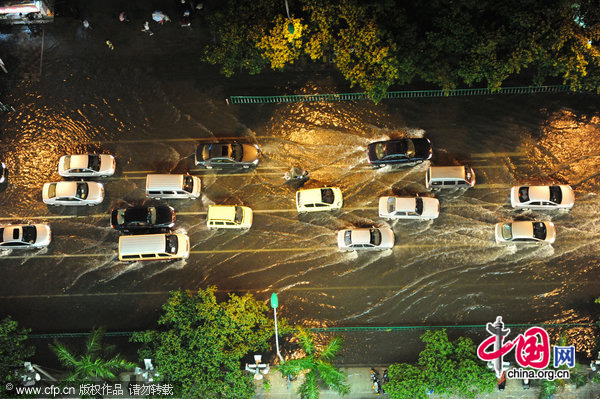 Cars run on a flooded road in Quanzhou, Fujian Province, after Typhoon Chanthu landed on Guangdong Province on July 22, 2010. Typhoon Chanthu brings rainstorm to Quanzhou.[Photo: CFP]