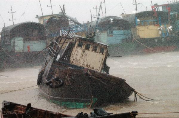 Photo taken on July 22, 2010 shows fishing boats anchored at Shapa Harbor in Yangjiang City, southern China's Guangdong Province. Chanthu, the third typhoon of the season, made landfall at the coastal area of Wuchuan City, southern China's Guangdong Province on Thursday afternoon, with winds near its center at 126 km per hour. Local meteorologists said Chanthu brought strong gales and torrential rains to many parts of the province, particularly in the west. [Zhou Ji/Xinhua] 