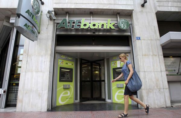 A woman walks in front of a branch of ATEbank in Athens July 23, 2010. Greek state-controlled lender ATEbank failed the bank stress tests on Friday. [Xinhua/Reuters] 