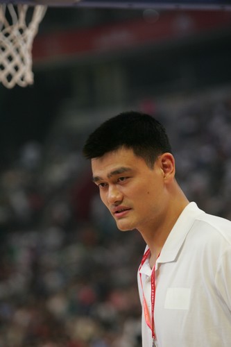 China's NBA star center Yao Ming reacts during a charity game in the name of his charity fund in Beijing July 24, 2010. A NBA all-star team led by star point guard Steve Nash visited Beijing for the game against China's national basketball team. [Photo\chinadaily.com.cn]