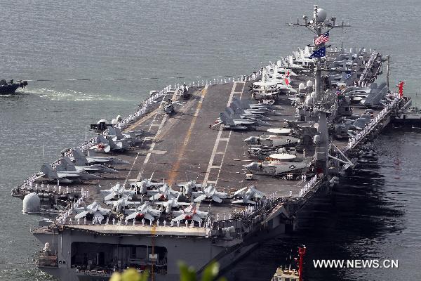 The U.S. nuclear-powered aircraft carrier USS George Washington leaves for joint naval and air drills with South Korea at a naval port in Busan, South Korea, July 25, 2010. South Korea and the United States on Sunday began their large-scale joint military drills off the east coast of the Korean Peninsula as scheduled. (Xinhua/Yonhap)