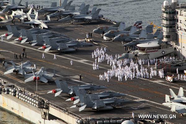 The U.S. nuclear-powered aircraft carrier USS George Washington leaves for joint naval and air drills with South Korea at a naval port in Busan, South Korea, July 25, 2010. South Korea and the United States on Sunday began their large-scale joint military drills off the east coast of the Korean Peninsula as scheduled. (Xinhua/Yonhap)