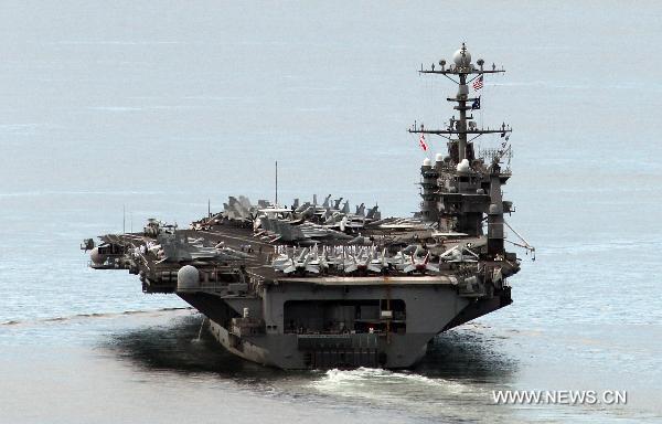 The U.S. nuclear-powered aircraft carrier USS George Washington leaves for joint naval and air drills with South Korea at a naval port in Busan, South Korea, July 25, 2010. South Korea and the United States on Sunday began their large-scale joint military drills off the east coast of the Korean Peninsula as scheduled. (Xinhua/Yonhap)