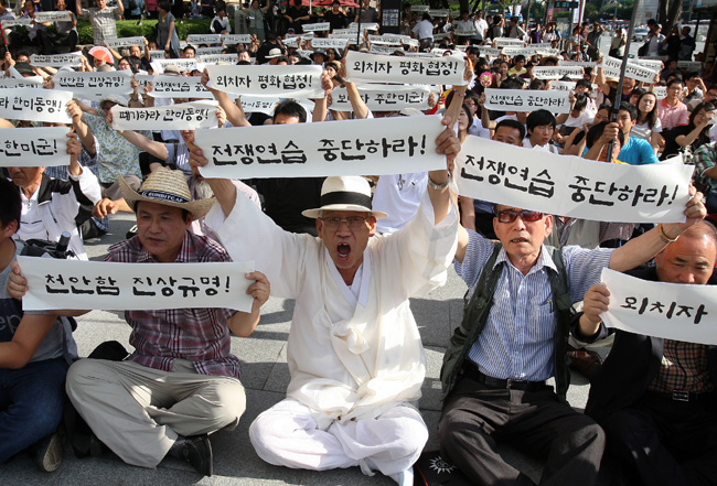 People attend the rally against South Korea and US&apos; joint military drills in Seoul, capital of South Korea, July 25, 2010. South Korea and the United States began their large-scale joint navy drills off the east coast of the Korean Peninsula on Sunday. [Xinhua]