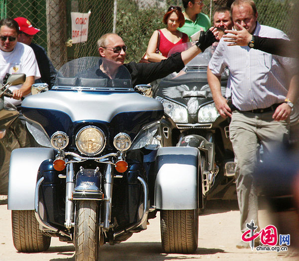 Russian PM Vladimir Putin rides a posh Harley Davidson trike at the 14th International bike show in Sevastopol. [CFP]