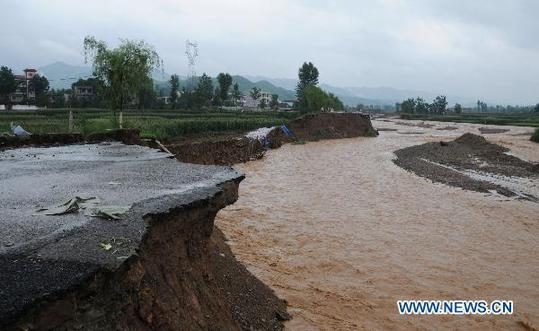 A road destroyed by flood is seen in Shanyang County, northwest China's Shaanxi Province, July 25, 2010. Nine people were killed and 15 others missing in the flood disasters caused by heavy rain hit on July 23 and 24 in the county. [Xinhua]