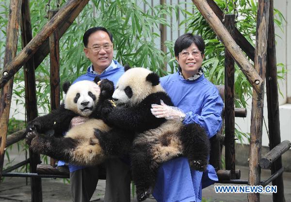 Donald Tsang Yam-Kuen (L), Chief Executive of China's Hong Kong Special Administrative Region, and his wife visit Bifeng Gorge Base of China Conservation and Research Center for the Giant Panda, located in southwest China's Sichuan Province, on July 25, 2010. 