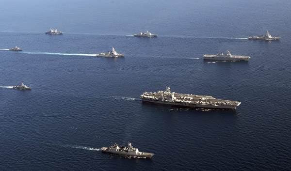 The U.S. nuclear-powered aircraft carrier USS George Washington (3rd R) leads South Korean and U.S. naval ships in formation during the U.S.-South Korea joint naval and air exercise in waters off the east coast of the Korean peninsula, July 26, 2010.[Xinhua/Reuters]