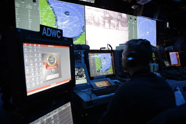 A crew member of the Nimitz-class USS George Washington works at the Combat Defense Centre during joint military exercises between the U.S. and South Korea in waters off the east coast of the Korean peninsula, July 26, 2010.[Xinhua/Reuters]