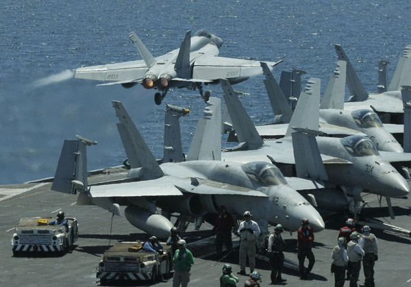 A U.S. Navy F/A-18F Super Hornet takes off from the flight deck of the Nimitz-class USS George Washington for joint military exercises between the U.S. and South Korea in waters off the east coast of the Korean peninsula, July 26, 2010.[Xinhua/Reuters]