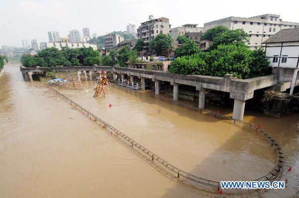 Photo taken on July 26, 2010 shows a flood-ravaged amusement park at Ciqikou ancient town in southwest China's Chongqing Municipality. [Xinhua] 