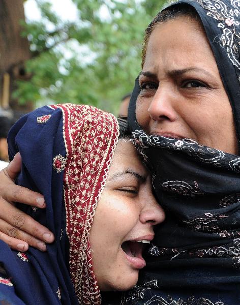 Pakistani women mourn their father after his death in a plane crash on the outskirts of Islamabad. A Pakistani airliner carrying up to 152 people crashed in a ball of flames Wednesday into densely wooded hills outside Islamabad amid heavy rain and poor visibility, killing everyone on board.(Xinhua/AFP Photo)
