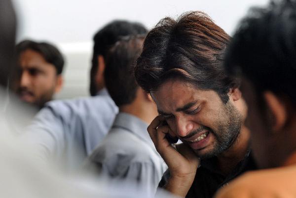 A Pakistani man mourn his relatives after his death in a plane crash on the outskirts of Islamabad. [Xinhua/AFP]