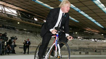 London Mayor Boris Johnson tries a test ride in the velodrome under construction, in the Olympic Park, east London, Britain, July 27, 2010.