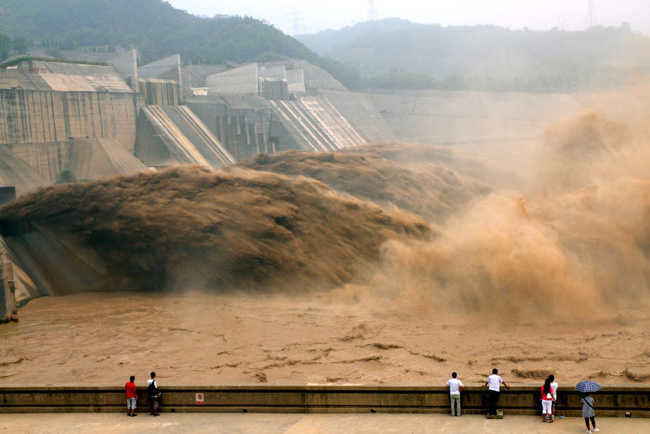 Floodwater rushes through the sluice gates of the Yellow River Xiaolangdi Dam in Luoyang, Henan province on July 27, 2010. The reservoir&apos;s inflow rose up to 1,500 cubic meters a second. [Photo: Xinhua]