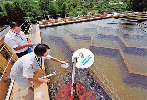 Employees of Shanghang Waterworks test water quality. [China Daily]