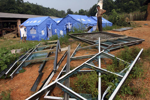 Villagers were evacuated to safety and housed in temporary shelters. Many homes and window frames were broken in Hutang village of Loudi, Central China's Hunan province, July 28, 2010. 