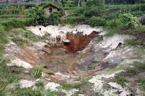 The ground caves in in Hutang village of Loudi, Central China's Hunan province, July 28, 2010. 