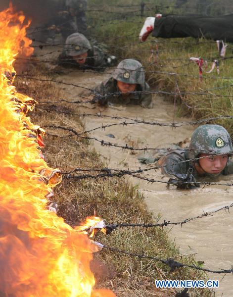 Soldiers practise skills during a psychological training at an army training field in Guangzhou, capital of south China's Guangdong Province, July 28, 2010, before the coming 83rd anniversary of the founding of the People's Liberation Army (PLA) which falls on August 1. 