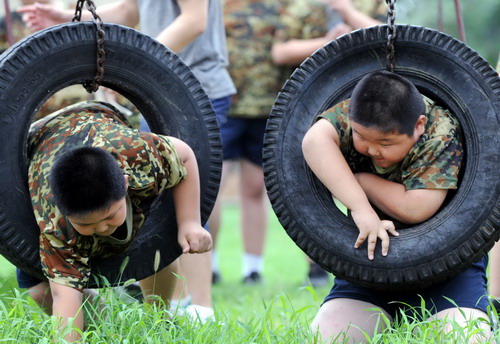 Boys do physical exercises at the training camp in Shenyang,capital of northeast China&apos;s Liaoning province on July 29, 2010.[Xinhua]
