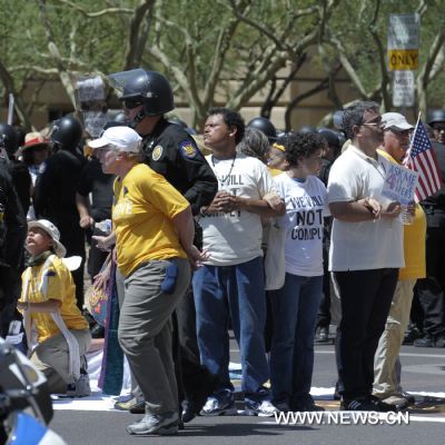 Protestors demonstrate against Arizona&apos;s controversial Senate Bill 1070 immigration law in downtown Phoenix, Arizona, the United States, July 29, 2010. The immigration law takes effect in Arizona on Thursday with some key portions blocked by U.S. District Court Judge Susan Bolton. [Xinhua]