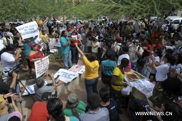 Protestors demonstrate against Arizona&apos;s controversial Senate Bill 1070 immigration law in downtown Phoenix, Arizona, the United States, July 29, 2010. The immigration law takes effect in Arizona on Thursday with some key portions blocked by U.S. District Court Judge Susan Bolton. [Xinhua]