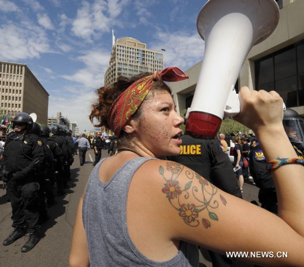 A protestor against Arizona&apos;s controversial Senate Bill 1070 immigration law chants slogans in downtown Phoenix, Arizona, the United States, July 29, 2010. The immigration law takes effect in Arizona on Thursday with some key portions blocked by U.S. District Court Judge Susan Bolton. [Xinhua]