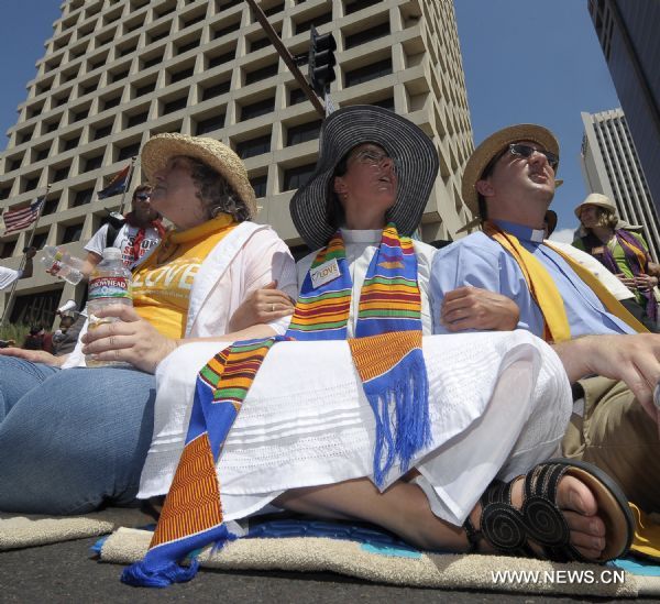 Protestors demonstrate against Arizona&apos;s controversial Senate Bill 1070 immigration law in downtown Phoenix, Arizona, the United States, July 29, 2010. The immigration law takes effect in Arizona on Thursday with some key portions blocked by U.S. District Court Judge Susan Bolton. [Xinhua]