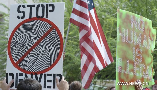 Protestors demonstrate against Arizona&apos;s controversial Senate Bill 1070 immigration law in downtown Phoenix, Arizona, the United States, July 29, 2010. The immigration law takes effect in Arizona on Thursday with some key portions blocked by U.S. District Court Judge Susan Bolton. [Xinhua]