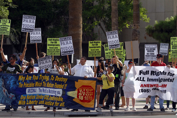 People protest outside the Arizona State Capitol after U.S. District Judge Susan Bolton blocked the most controversial sections of Arizona&apos;s new Senate Bill 1070 immigration law in Phoenix July 28, 2010. Bolton on Wednesday blocked key parts of Arizona&apos;s tough new immigration law just hours before it was to take effect, handing a victory to the Obama administration as it tries to take control over the issue. [Xinhua/Reuters]