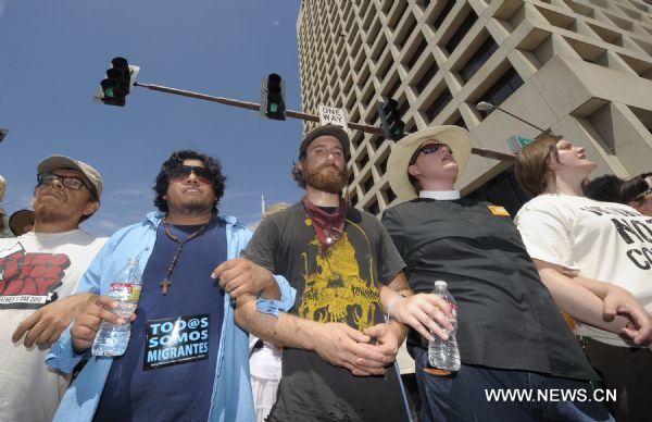 Protestors demonstrate against Arizona&apos;s controversial Senate Bill 1070 immigration law in downtown Phoenix, Arizona, the United States, July 29, 2010. The immigration law takes effect in Arizona on Thursday with some key portions blocked by U.S. District Court Judge Susan Bolton. [Qi Heng/Xinhua]