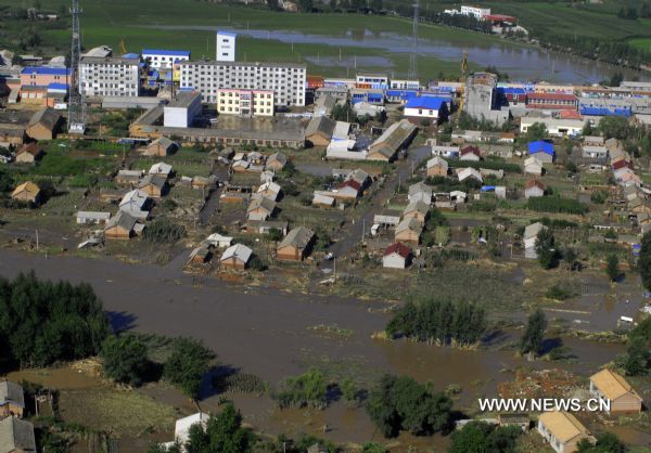 The aerial photo taken on July 29, 2010 shows the flood-stricken towns and villages of Yongji County, northeast China's Jilin Province.
